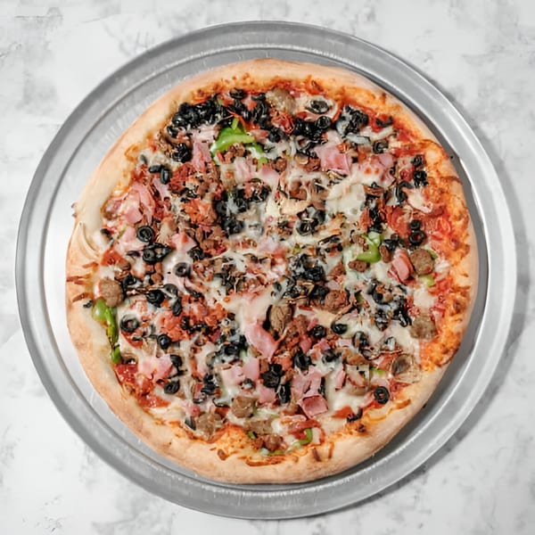 A whole Pointer's Pizza with various toppings including black olives, ham, and green peppers.